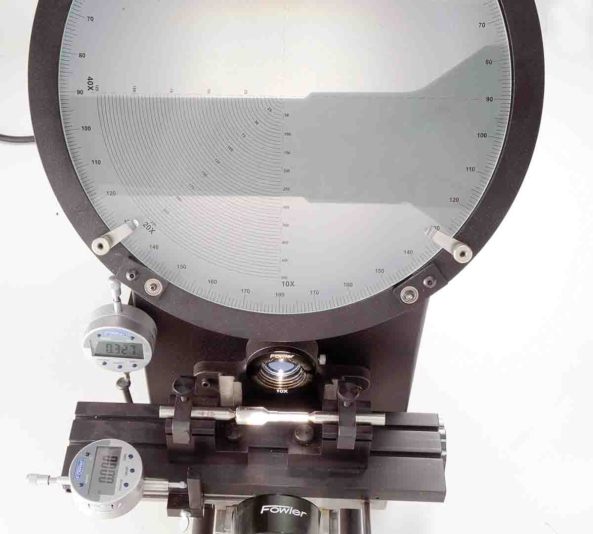The chamber cast was gauged with an optical comparator to gain the most precise measurements possible. The comparator shines a bright light on the chamber cast and projects a magnified and precise shadow profile. It has a mechanism that translates table movement and the chamber cast to inches by means of digital indicators.